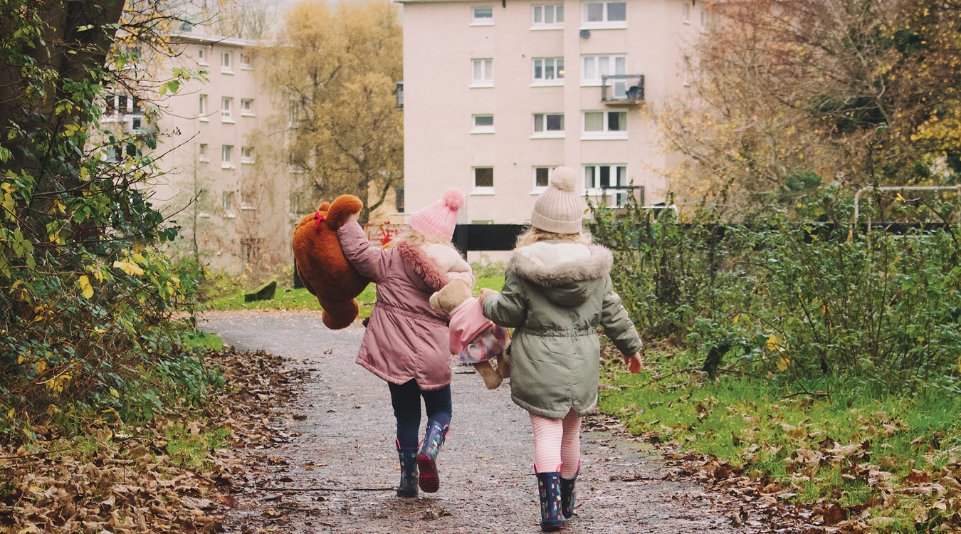 Girls walking holding Boyd's bear