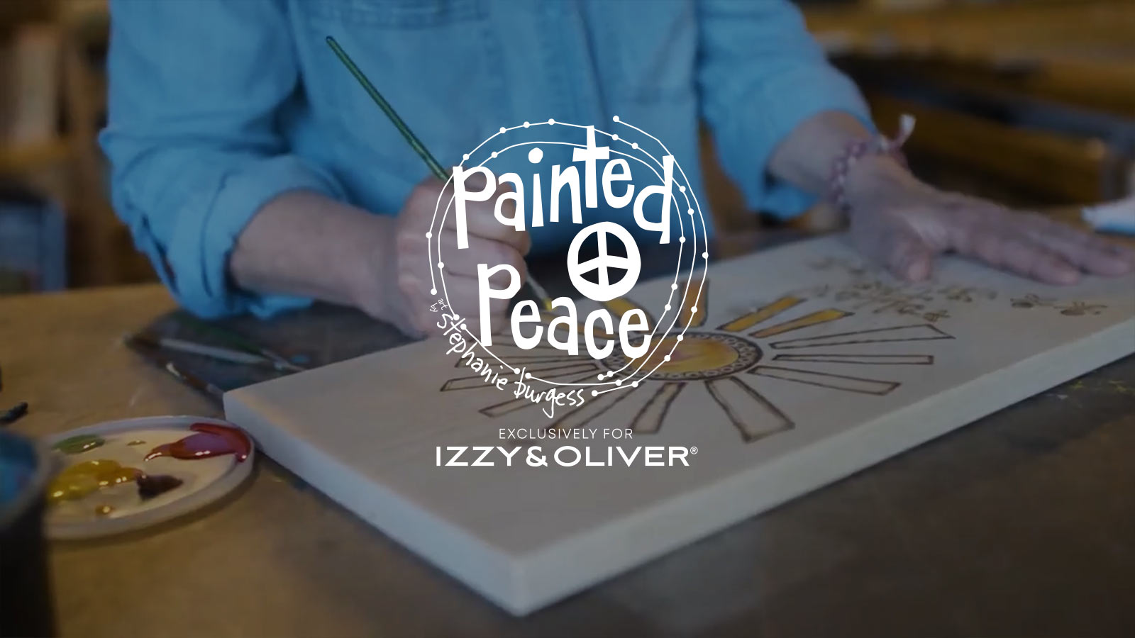 Image of artist and Painted Peace for Izzy & Oliver Logo